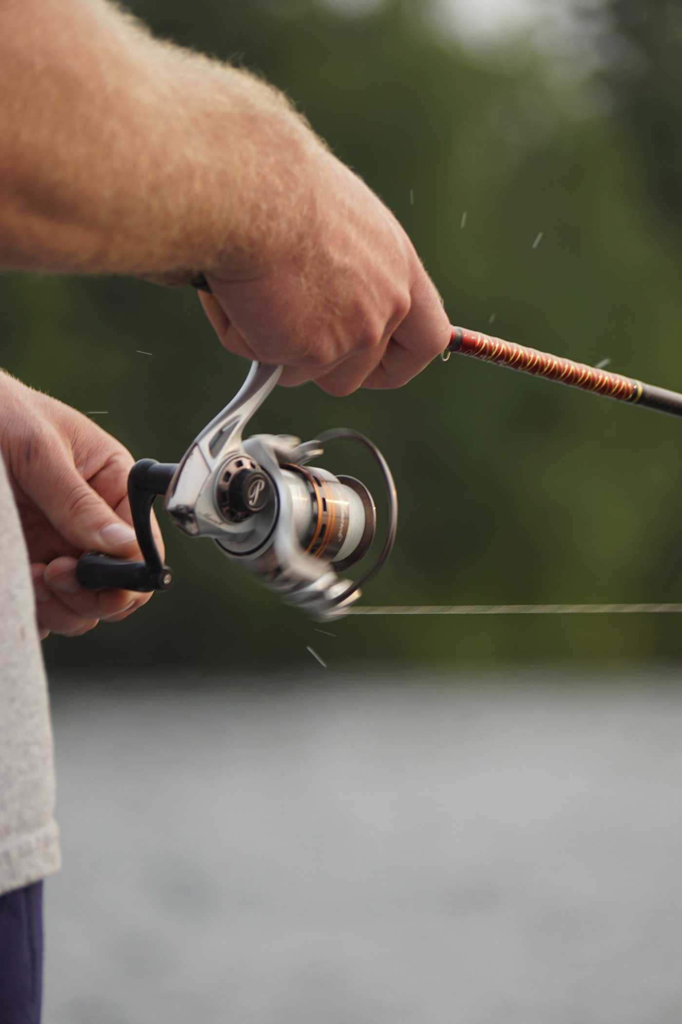 Hands on a fishing reel